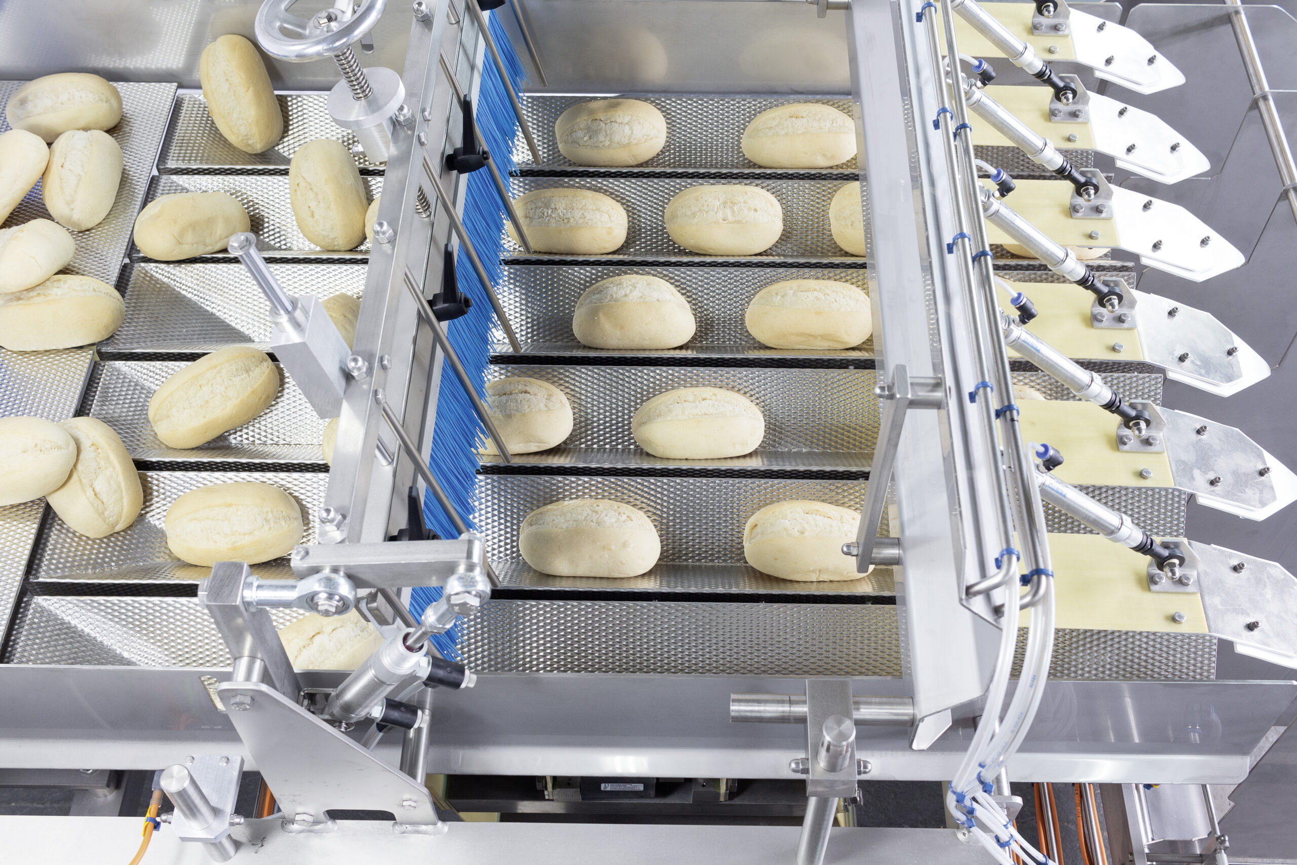 Buns s run through the chutes of a weighing machine.